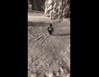 Guy grind tube rail with ice skates and lands in snow