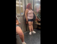 Woman stand on train with long nails