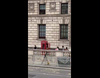 Collab IITW - Woman poses at the red telephone booth