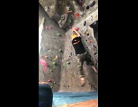 Slow motion guy leap spin to higher rock 