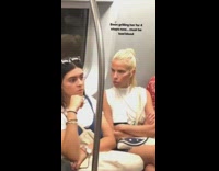 Angry blonde girl staring down girl next to her subway sitting