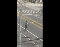 Guy practices boxing in middle of street