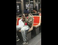 Guy stares at phone with big wide eyes on subway train