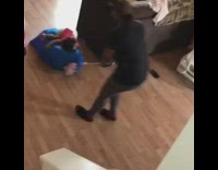 Baby girl lays on a laundry sack bag, gets pulled around the living room by her mom, face plants into the floor