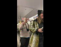 The Jolly Cat red green striped shirt screams on microphone on subway train