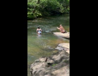 Woman blue bikini poses at the river