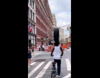 Collab WINY - Man on bike balancing tire on head 