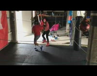 Two kids siblings practice boxing ring flags