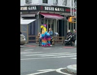 Guy in Piñata Costume Prepares to Cross the Street 