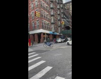 Guy on bicycle decides to be michelle kwan in traffic in intersection