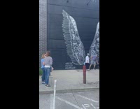 People wait in line for wings mural