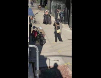 Lady wears black masquerade mask and dress 