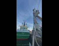 Guy standing on top of mast does backflip 