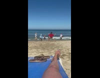 Man red shirt legs apart yoga beach