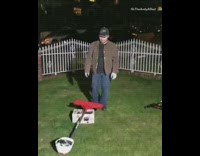 Guy seesaw kicks a helmet off a shovel and tries to land it perfectly on his head