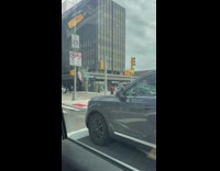 Guy crosses street with head down 