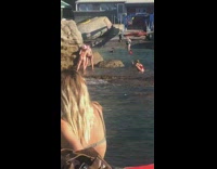 Two girls bikini kiss beside rock beach