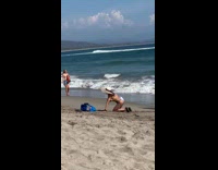 Collab IITW - Woman in a floral bikini and a hat poses at the beach