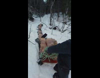 Guy pulls firewood on plastic bags snow 