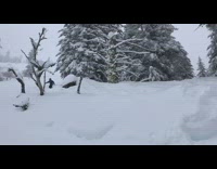 Guy rides red snowboard over rock fail