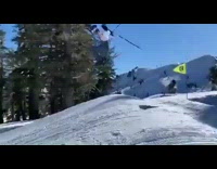 Skier falls while jumping windy