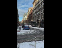 Car pulls guy on skis down road 