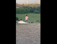 Man pink top dances at the park