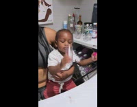 Baby boy cheers with adults 