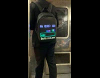 Guy wears sue NYPD lit backpack 