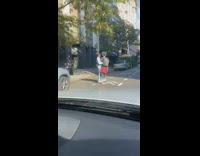 Couple ride one hoverboard together 