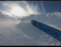 Snowboarder grinds on rail, falls and chest lands on rail