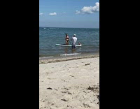 Girl black bikini kneel paddle board beach