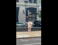 Woman with spikes design poses on sidewalk