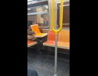 Woman rides train holds orange seat props