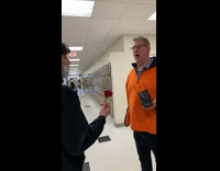 Guy offers teacher flower and he laughs