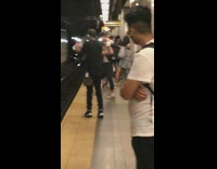 Guy blows O ring shape with vape cloud in subway station