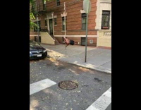 Guy hangs parallel to sidewalk metal pole 