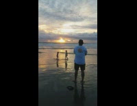 Two children stand sunset beach photo shoot