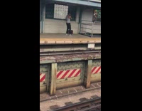 Guy does cable rope arm exercise at train stop
