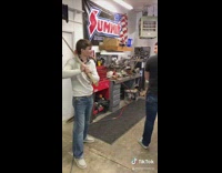 Guy hits friend in back with wood sword 