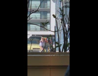 Two guys dance together in parking lot for selfie video