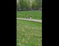 Girl jeans jump raise arms park flowers