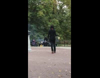 Guy holds black stick on fire park 