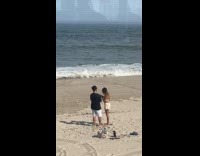 Couple poses for photoshoot at the beach Part 2