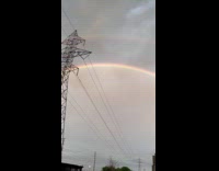 Two rainbow arc seen behind the tower