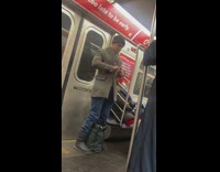 Guy cutting his nails with scissors on subway