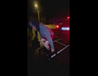 Man exercises and lifts different cars in the parking lot