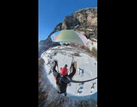 Woman wearing parachute floats down to ground 