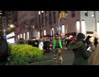 Guy standing on street wears jester hat 