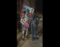 Man sings with karaoke cow on street